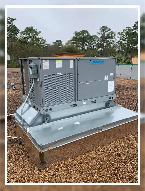 A large air conditioner sitting on top of a metal platform.